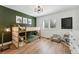 Charming bedroom with a bunk bed, a lovely light fixture, and decoratively painted green accent wall at 34103 Forest Park Dr, Elizabeth, CO 80107