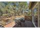 Inviting deck area with an outdoor dining set, perfect for enjoying the surrounding forest views at 34103 Forest Park Dr, Elizabeth, CO 80107