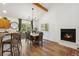 Dining area with hardwood floors, a chandelier, and adjacent seating near a cozy fireplace at 34103 Forest Park Dr, Elizabeth, CO 80107