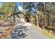 A two-car garage showcasing the home's convenient parking and access, set against wooded backdrop at 34103 Forest Park Dr, Elizabeth, CO 80107