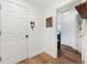 Hallway with a door, hardwood floors, and a decorative key rack at 34103 Forest Park Dr, Elizabeth, CO 80107