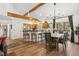 Open-concept kitchen and dining area with wood floors and natural light from the large windows at 34103 Forest Park Dr, Elizabeth, CO 80107