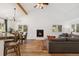 Vaulted ceilings enhance an open living area with a fireplace, dining space, and hardwood floors at 34103 Forest Park Dr, Elizabeth, CO 80107