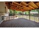 Expansive wood deck with a covered area for outdoor enjoyment and relaxing in a backyard setting at 9575 Garland Ct, Westminster, CO 80021