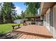 Expansive backyard with a wooden deck, pergola, shed, and mature trees, perfect for relaxation and entertainment at 9575 Garland Ct, Westminster, CO 80021