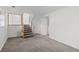 Finished basement area with modern staircase, gray carpet and side laundry area at 9575 Garland Ct, Westminster, CO 80021