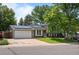 A suburban home featuring solar panels, a two-car garage, and a well-manicured front lawn at 9575 Garland Ct, Westminster, CO 80021