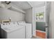 Functional laundry room with a washer, dryer, and shelf space for storage, blending utility with convenience at 9575 Garland Ct, Westminster, CO 80021