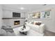Comfortable living room featuring a fireplace, a large sofa, and bright windows at 9575 Garland Ct, Westminster, CO 80021