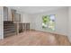 Bright and airy living room with a modern staircase, laminate floors, and a large window for natural light at 9575 Garland Ct, Westminster, CO 80021