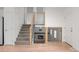 Modern staircase with wood and metal railings overlooking a cozy living area with a fireplace at 9575 Garland Ct, Westminster, CO 80021