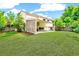 Expansive backyard featuring lush green lawn, mature trees and spacious covered patio, perfect for outdoor living and entertaining at 3612 Rosewalk Cir, Highlands Ranch, CO 80129