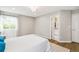 Bright bedroom featuring a closet, large windows with natural light, and entry to bathroom at 3612 Rosewalk Cir, Highlands Ranch, CO 80129