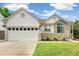 Charming single-Gathering home with stone accents, lush lawn, and attached two-car garage at 3612 Rosewalk Cir, Highlands Ranch, CO 80129