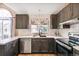 Updated kitchen with stainless steel appliances, dark cabinetry, and bright natural light at 3612 Rosewalk Cir, Highlands Ranch, CO 80129