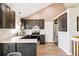 Modern kitchen with stainless appliances, white backsplash, gray cabinets, and wood floors at 3612 Rosewalk Cir, Highlands Ranch, CO 80129
