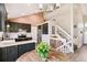 Eat-in kitchen with stainless appliances, wood floors, gray cabinets, and view to the living room at 3612 Rosewalk Cir, Highlands Ranch, CO 80129