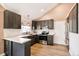 Modern kitchen with stainless appliances, white backsplash, gray cabinets, and wood floors at 3612 Rosewalk Cir, Highlands Ranch, CO 80129