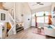 Bright, open living room with high ceilings, a ceiling fan, wood floors, and ample natural light at 3612 Rosewalk Cir, Highlands Ranch, CO 80129