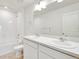Bathroom boasts double sinks, a vanity, and a shower over tub at 18120 Dandy Brush Ln, Parker, CO 80134