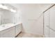 Bright bathroom featuring double sink vanity and frameless glass shower enclosure at 18120 Dandy Brush Ln, Parker, CO 80134