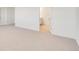 Spacious bedroom featuring neutral carpet leading to ensuite bathroom at 18120 Dandy Brush Ln, Parker, CO 80134