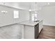 Open concept kitchen featuring an island with granite countertops and stainless steel dishwasher overlooking living area at 18120 Dandy Brush Ln, Parker, CO 80134