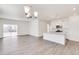 Open-concept kitchen featuring a granite-topped island, white cabinets, and a view of the bright living area at 18120 Dandy Brush Ln, Parker, CO 80134