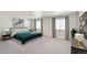 Bright main bedroom with soft carpet, neutral walls, large windows with curtains, and stylish furnishings at 18120 Dandy Brush Ln, Parker, CO 80134