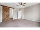 Primary bedroom with barn door and carpet flooring at 4715 River Highlands Loop, Elizabeth, CO 80107