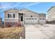 Charming exterior view of a gray single Gathering home featuring an attached three-car garage at 4715 River Highlands Loop, Elizabeth, CO 80107