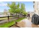 Outdoor patio with grass, flowers, and a view of the community pool at 12973 Grant E Cir # A, Thornton, CO 80241