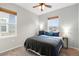 Cozy bedroom with a ceiling fan, two windows, and neutral walls at 12973 Grant E Cir # A, Thornton, CO 80241