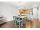 Bright dining area with hardwood floors, modern chandelier, and table with seating for four at 12973 Grant E Cir # A, Thornton, CO 80241