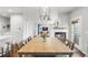 Dining room featuring a long table, fireplace, and open view to living area, filled with natural light at 12973 Grant E Cir # A, Thornton, CO 80241
