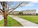 Exterior townhome view showing sidewalk and manicured lawn at 12973 Grant E Cir # A, Thornton, CO 80241