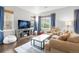 Cozy living room featuring hardwood floors, large windows and comfortable seating at 12973 Grant E Cir # A, Thornton, CO 80241