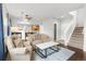 Open-concept living room with hardwood floors and staircase at 12973 Grant E Cir # A, Thornton, CO 80241
