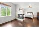 Bright main bedroom featuring stone fireplace, hardwood floors, and view to backyard at 12973 Grant E Cir # A, Thornton, CO 80241