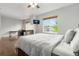 Inviting main bedroom with a stone fireplace, hardwood floors, and a large window at 12973 Grant E Cir # A, Thornton, CO 80241