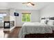 Spacious main bedroom with stone fireplace, hardwood floors, and a large window at 12973 Grant E Cir # A, Thornton, CO 80241