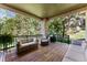 Back porch with cozy seating, a grill, and a view of the lush greenery at 3104 Ramshorn Dr, Castle Rock, CO 80108