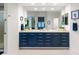 A bathroom with double sinks, granite countertops, and a bright mirror, next to a glass enclosed shower at 3104 Ramshorn Dr, Castle Rock, CO 80108