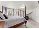 Spacious bedroom with a four-poster bed, a comfortable chair, and natural light from the windows at 3104 Ramshorn Dr, Castle Rock, CO 80108