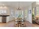 Charming dining area with bay windows, modern lighting, and an adjacent breakfast nook at 3104 Ramshorn Dr, Castle Rock, CO 80108