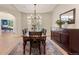 Elegant dining room with traditional chandelier, hardwood floors, and a classic wooden dining set at 3104 Ramshorn Dr, Castle Rock, CO 80108