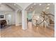 Grand entryway features hardwood floors, open staircase, and a view into the spacious living area at 3104 Ramshorn Dr, Castle Rock, CO 80108