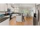 Bright kitchen boasts white cabinetry, granite countertops, stainless steel appliances, and dining area access at 3104 Ramshorn Dr, Castle Rock, CO 80108