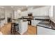 Well-appointed kitchen features white cabinets, dark countertops, stainless appliances, and modern bar seating at 3104 Ramshorn Dr, Castle Rock, CO 80108
