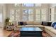 Bright living room featuring a large sectional sofa, oversized windows, and stylish interior design at 3104 Ramshorn Dr, Castle Rock, CO 80108